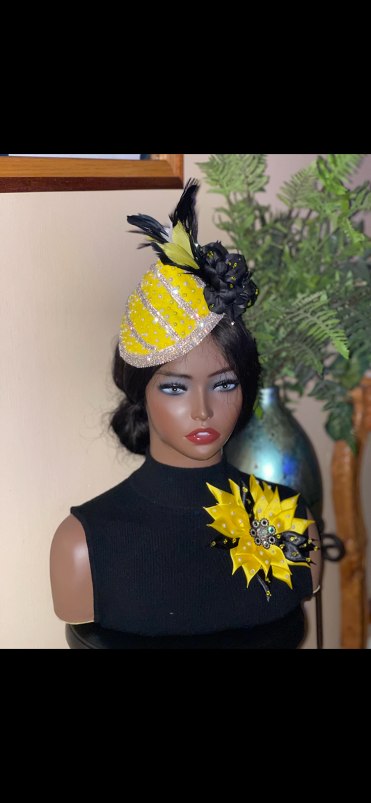 Yellow and black fascinator hat and brooch.